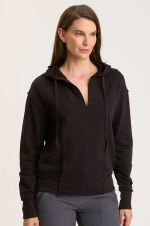 Woman wearing a black hoodie on a white background