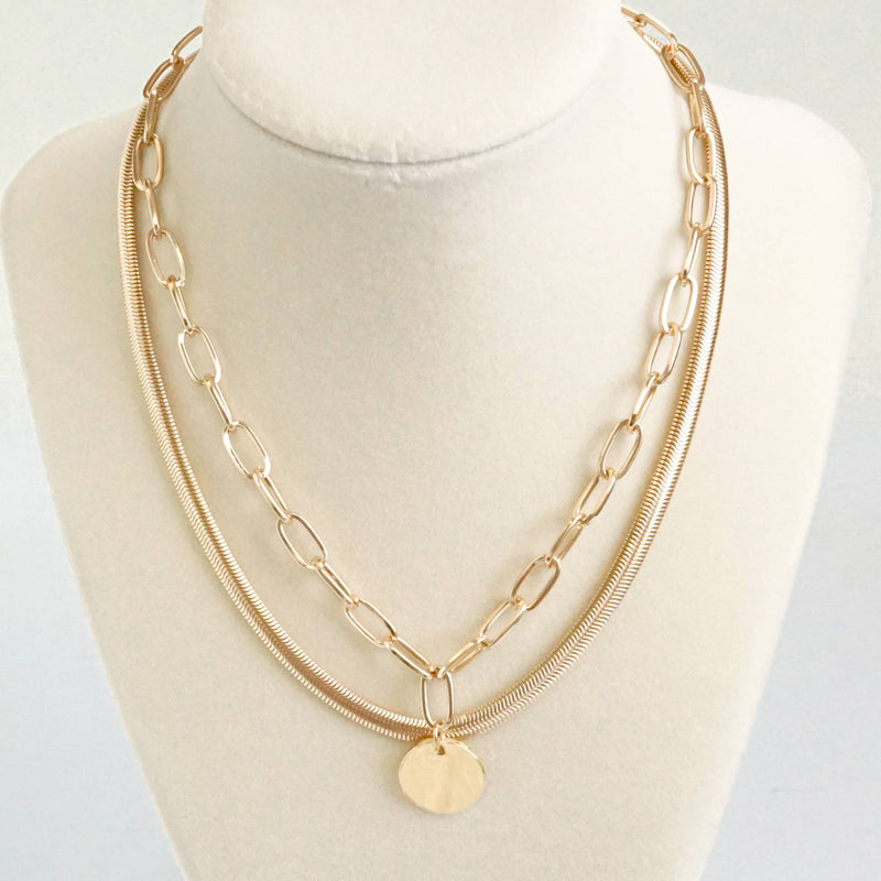 Layered gold tone short necklace set with a coin pendant