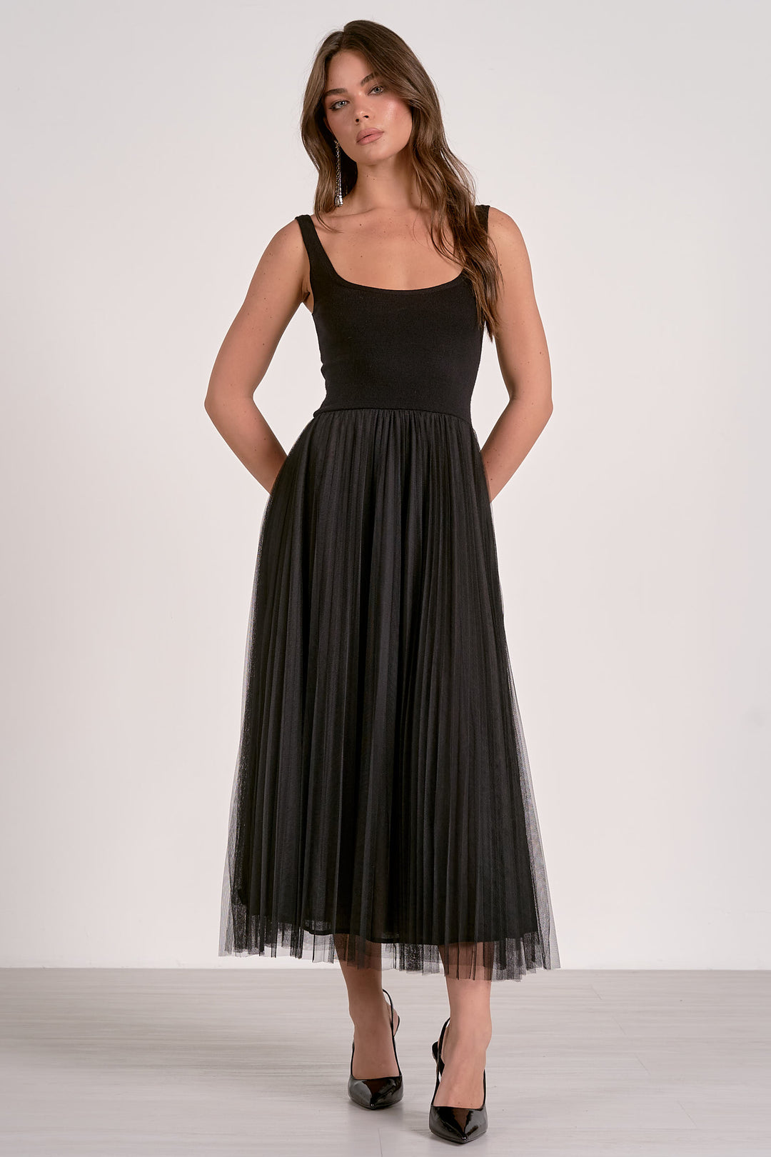 Woman wearing a black dress against a white background