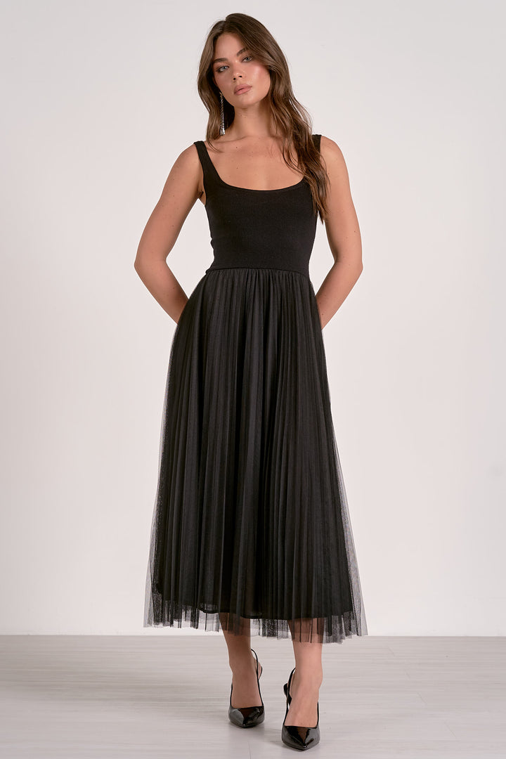 Woman wearing a black dress against a white background